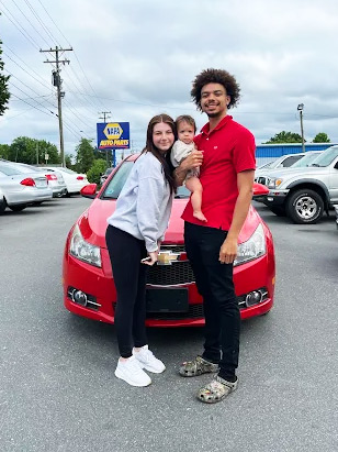 Happy family at Oak Auto NC Kernersville with their quality pre-owned vehicle